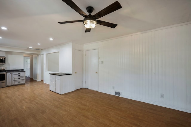 unfurnished living room with light hardwood / wood-style flooring, ceiling fan, and crown molding