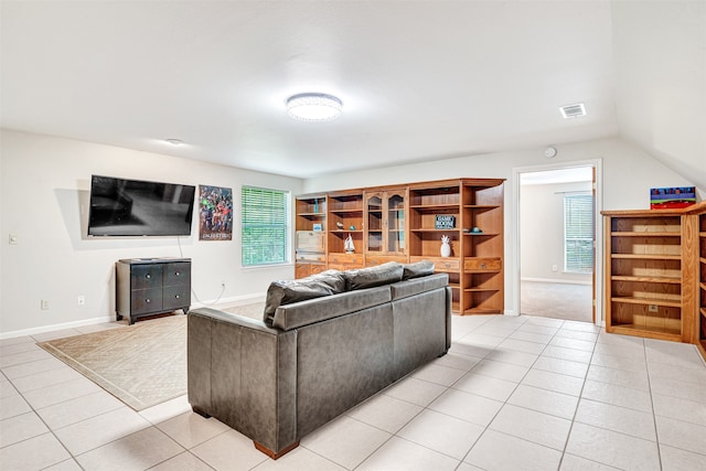 living room featuring a healthy amount of sunlight, light colored carpet, and vaulted ceiling