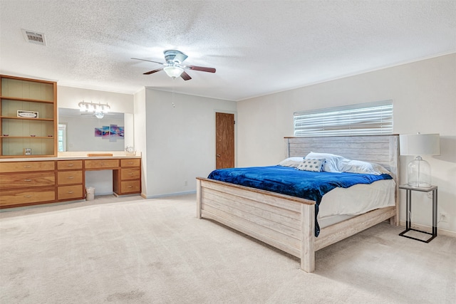 carpeted bedroom with a textured ceiling and ceiling fan