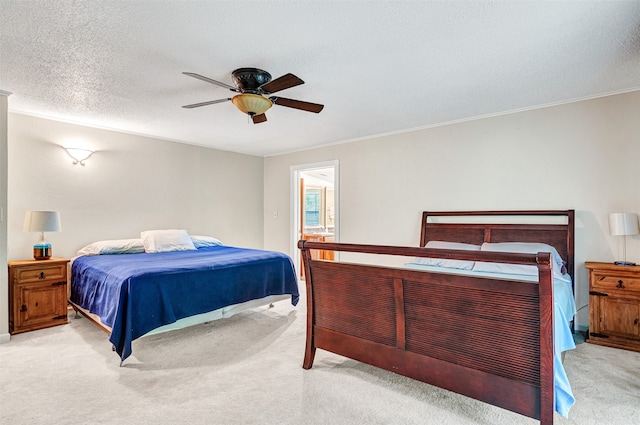 carpeted bedroom featuring a textured ceiling and ceiling fan