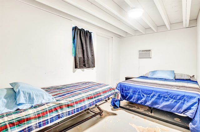 bedroom with a wall unit AC, beamed ceiling, and concrete floors