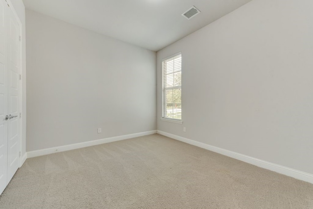 unfurnished room featuring light colored carpet