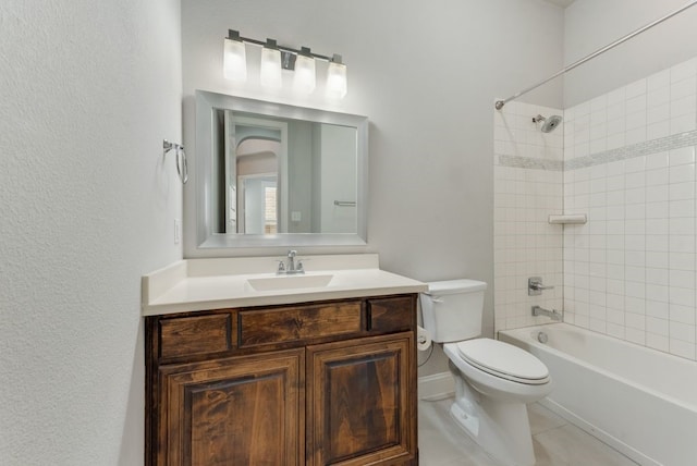 full bathroom featuring vanity, tile patterned floors, toilet, and tiled shower / bath