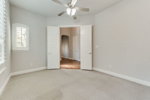 unfurnished bedroom with light colored carpet and ceiling fan