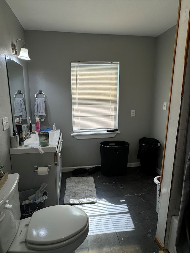 bathroom featuring vanity, toilet, and tile patterned flooring