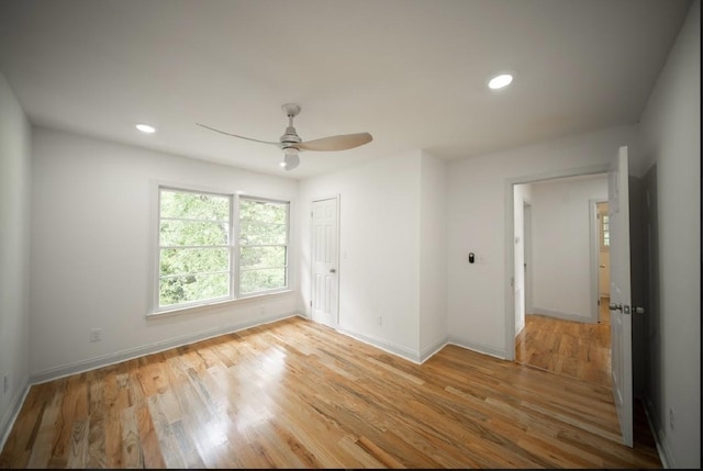 spare room with light hardwood / wood-style flooring and ceiling fan