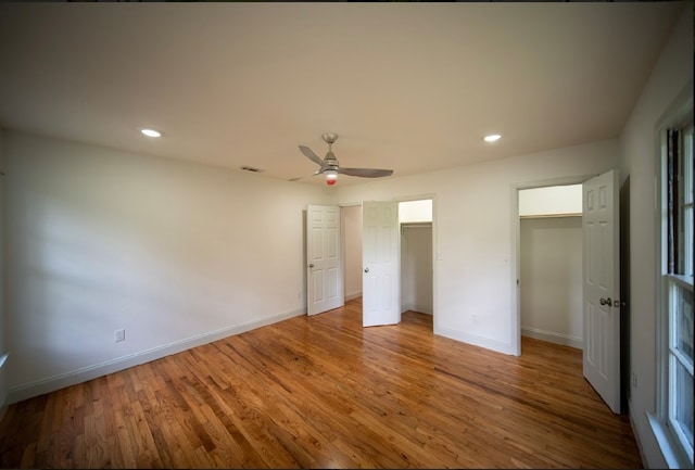 unfurnished bedroom featuring wood-type flooring and ceiling fan