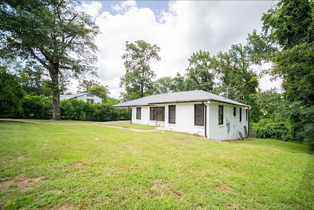 back of house featuring a yard