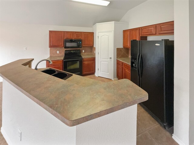 kitchen with light tile patterned flooring, black appliances, sink, lofted ceiling, and backsplash