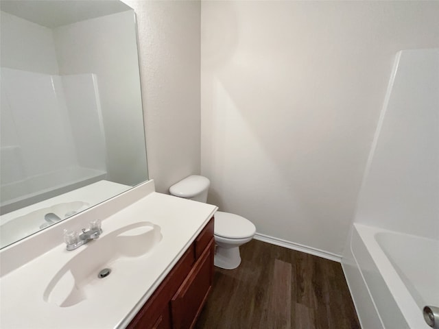 full bathroom with shower / bathtub combination, vanity, wood-type flooring, and toilet