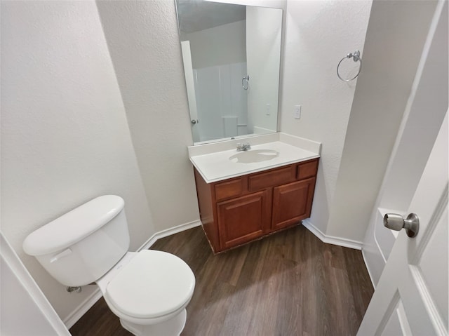 bathroom with vanity, hardwood / wood-style flooring, and toilet