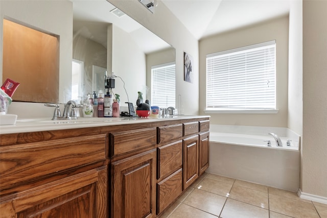 bathroom featuring vanity, tile patterned floors, and a tub