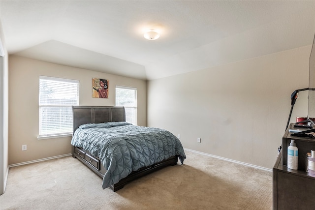 carpeted bedroom featuring lofted ceiling