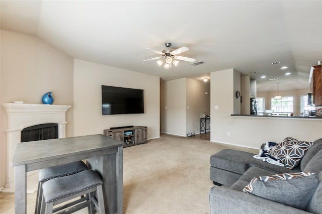 living room with lofted ceiling, carpet flooring, and ceiling fan