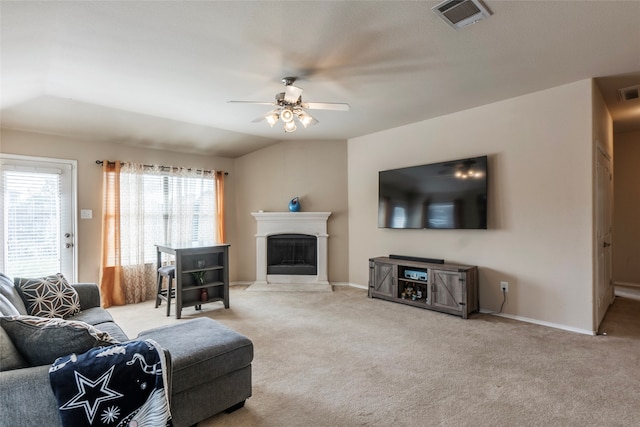 living room featuring vaulted ceiling, light colored carpet, and ceiling fan