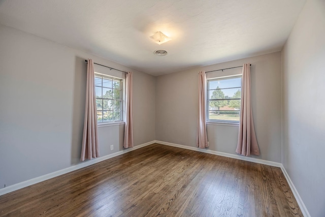 spare room featuring hardwood / wood-style floors