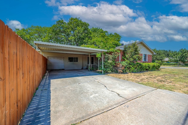 exterior space featuring a front yard, a garage, and a carport