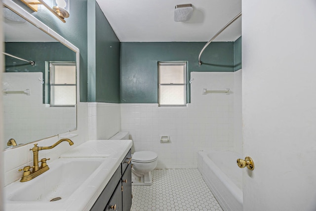 full bathroom featuring vanity, tile walls, tile patterned flooring, shower / washtub combination, and toilet