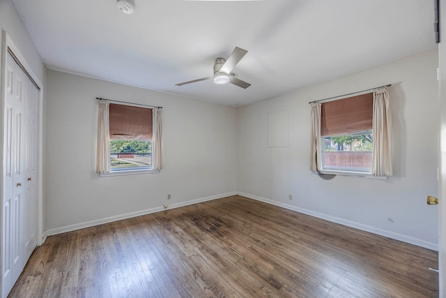 spare room featuring wood-type flooring, ceiling fan, and a healthy amount of sunlight