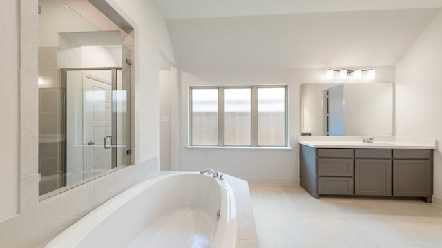 bathroom featuring vaulted ceiling, tile patterned flooring, vanity, and plus walk in shower