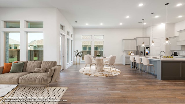 dining area with a towering ceiling and dark hardwood / wood-style floors