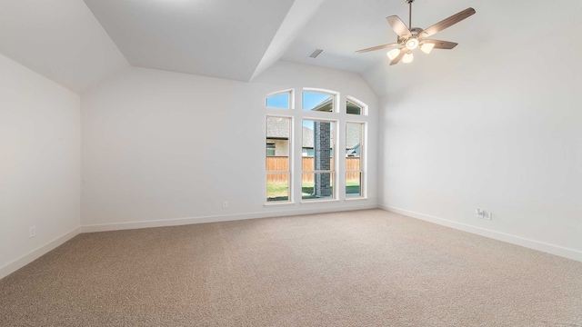 carpeted empty room with ceiling fan and vaulted ceiling