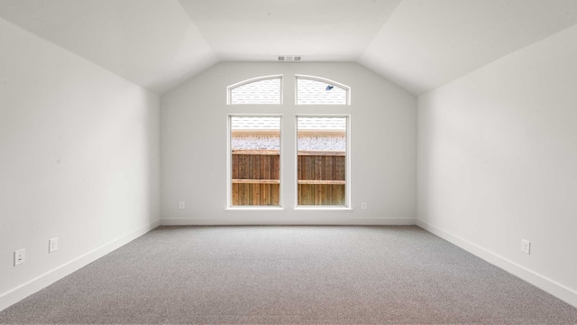 bonus room with carpet floors and vaulted ceiling