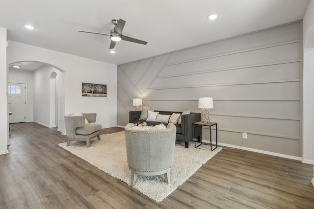 living room with hardwood / wood-style floors and ceiling fan