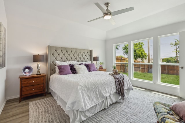 bedroom with hardwood / wood-style flooring, multiple windows, and ceiling fan