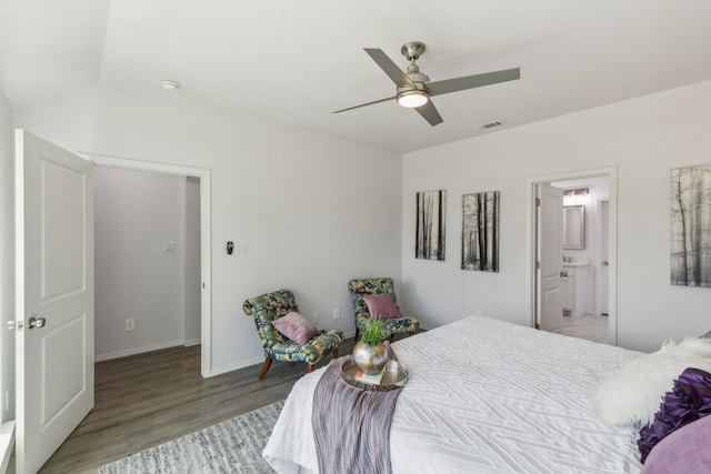 bedroom with connected bathroom, ceiling fan, and light hardwood / wood-style flooring