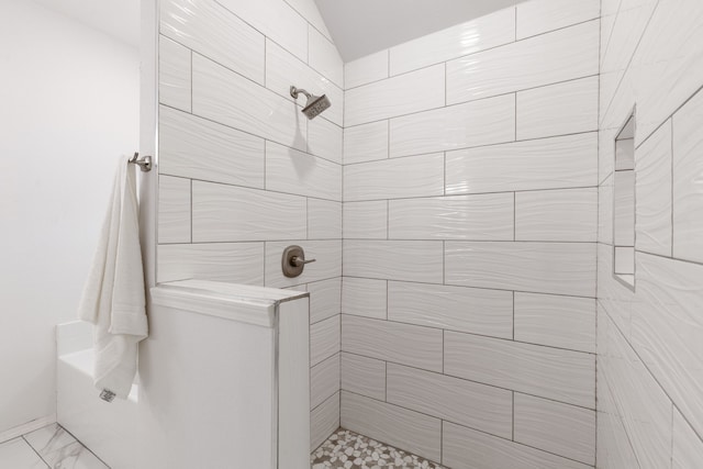 bathroom with tiled shower