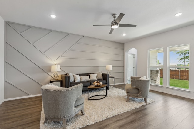 living room featuring dark hardwood / wood-style flooring and ceiling fan