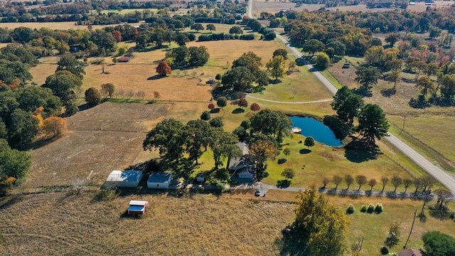 birds eye view of property with a water view and a rural view