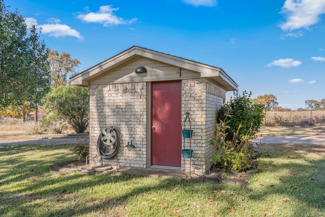 view of outbuilding featuring a yard