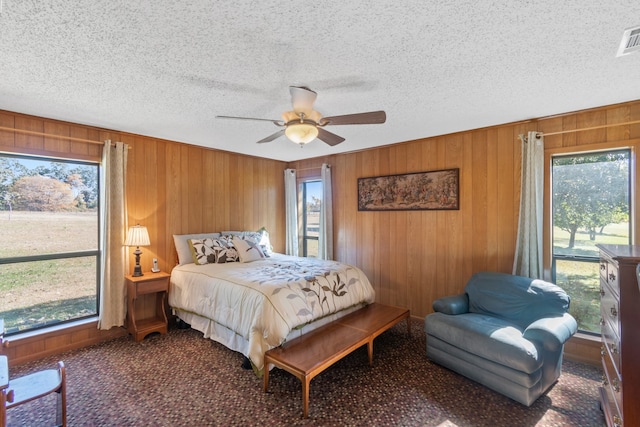 bedroom with multiple windows, carpet floors, and ceiling fan