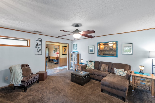 living room featuring a textured ceiling, carpet floors, and ceiling fan