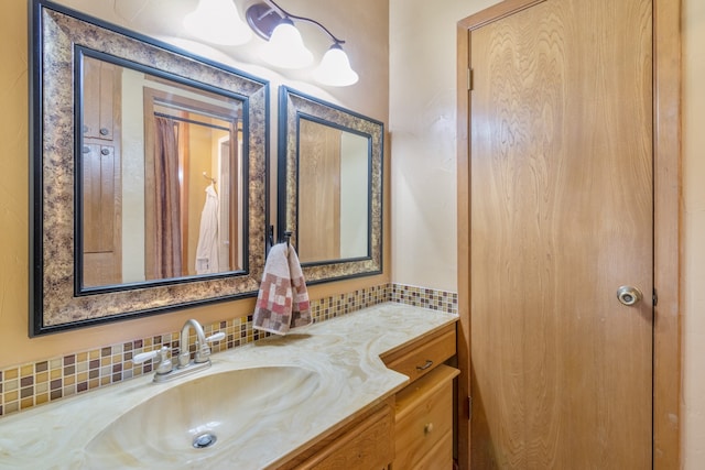 bathroom featuring vanity and backsplash