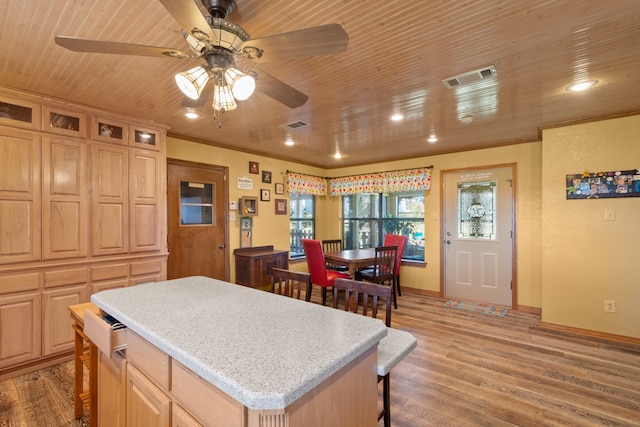 kitchen featuring a kitchen island, wooden ceiling, ceiling fan, and hardwood / wood-style floors