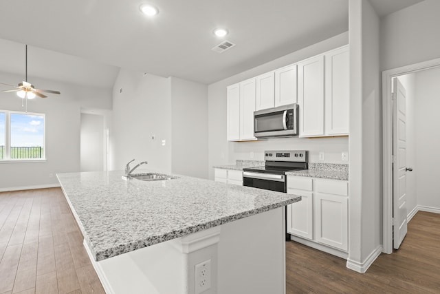 kitchen featuring white cabinets, a center island with sink, and appliances with stainless steel finishes