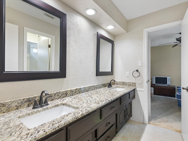 bathroom with double vanity, tile patterned flooring, and ceiling fan