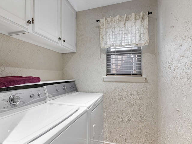 washroom featuring washing machine and dryer and cabinets