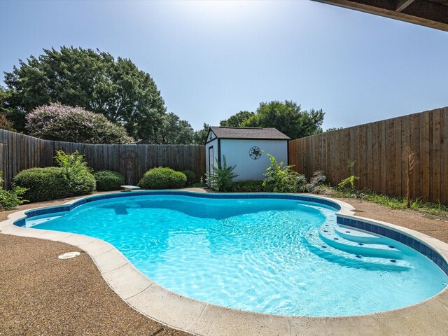 view of swimming pool featuring a shed