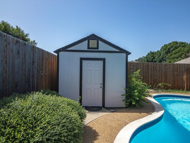 view of swimming pool with a storage unit