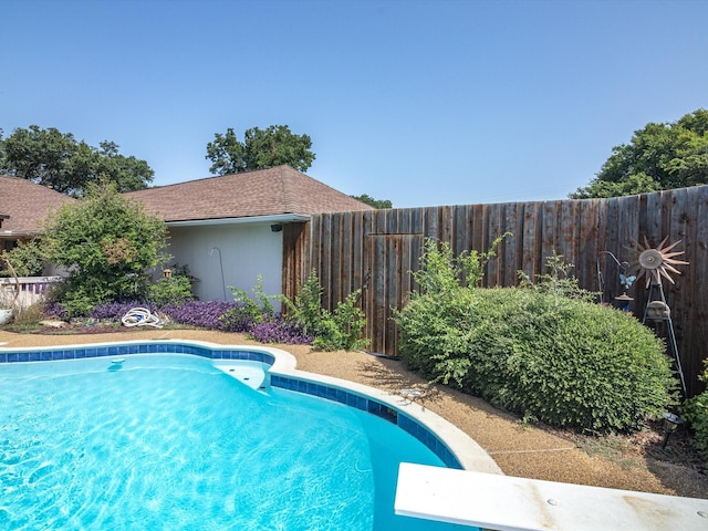 view of pool featuring a diving board