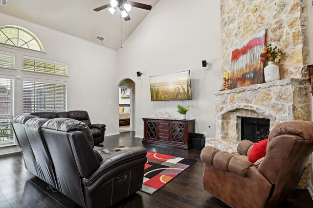 living room featuring ceiling fan, high vaulted ceiling, dark hardwood / wood-style flooring, and a fireplace