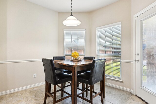 dining space featuring light tile patterned floors and a wealth of natural light