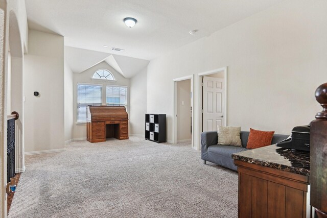 living area with vaulted ceiling and light carpet