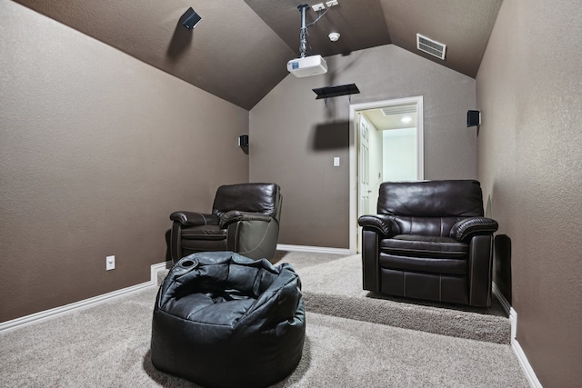 cinema room with lofted ceiling and carpet floors