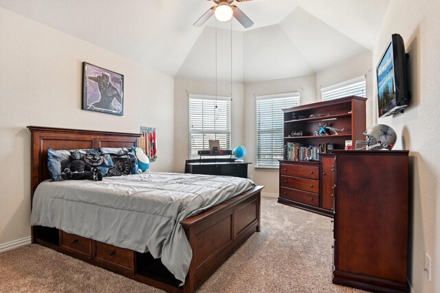 carpeted bedroom with ceiling fan and vaulted ceiling