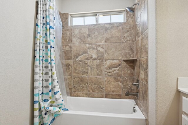 bathroom featuring shower / tub combo and vanity